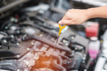 woman hand  check oil level in car engine. Self Maintenance, repair and problem concept - obrazy, fototapety, plakaty