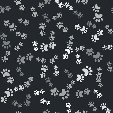 Grey Paw print icon isolated seamless pattern on black background. Dog or cat paw print. Animal track. Vector