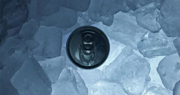 Tin can in ice rotating top view closeup footage