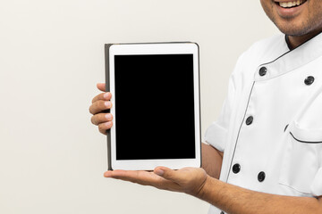 Close up male hands chef showing empty screen digital tablet to choose various delicious dish menu good taste for customer order. Online delivery food buying variety of dish