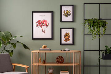 The stylish composition at living room interior with wooden console and elegant personal accessories. Mock up poster. Green wall. Plants in cozy apartment. Home decor. Template.