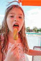 Little girl eats ice cream. Child in the summer in the park.