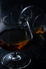 Two cognac glasses on a dark background