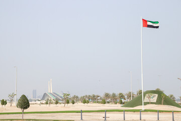 Fototapeta premium National flag of UAE in Abu dhabi island on a bright day