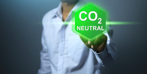 Hand press to activate the CO2 neutral icon renewable energy-based green businesses limit climate...