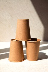 Zero waste concept. Paper glasses on a stone beige background. Front view