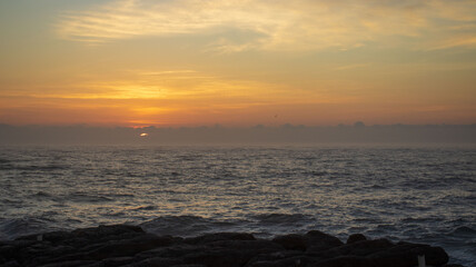 Fototapeta na wymiar A early morning sunrise seen over the ocean on the south coast of South Africa