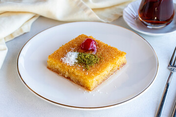 Kadayif dessert with pistachio on a white background. Traditional Turkish cuisine delicacies. close up