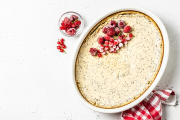 Healthy cottage cheese casserole, poppy seeds, frozen berries. Top view, copy space.