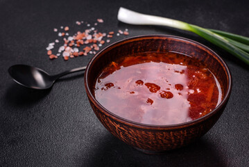 Traditional Ukrainian borsch. Bowl of red beet root soup borsch with green onion