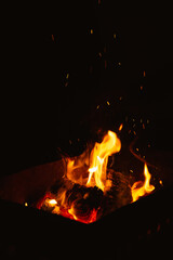 burning firewood in the brazier at night, flames of fire in the dark