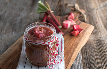 Homemade rhubarb compote on wooden table - obrazy, fototapety, plakaty