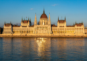 Fototapeta na wymiar Hungarian parliament in Budapest at sunset with golden reflection in Danube