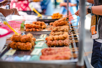 Breaded chicken skewers are sold at Bang Son Market, Bangkok, Thailand