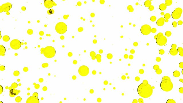 Oil liquid background. Golden yellow bubbles drops isolated in motion. Oils, food, cosmetics, drinks, liquids concept