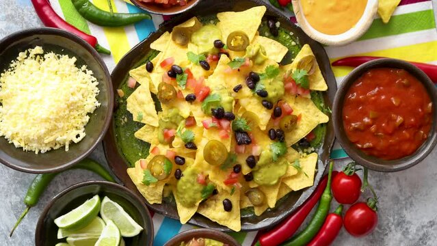 Mexican nachos tortilla chips with black bean, jalapeno, guacamole