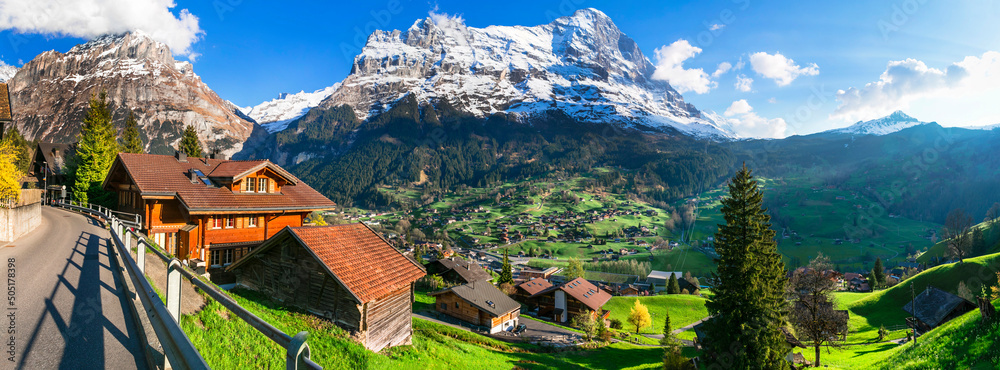 Wall mural Switzerland nature and travel. Alpine scenery. Scenic traditional mountain village Grindelwald surrounded by snow peaks of Alps. Popular tourist destination and ski resort