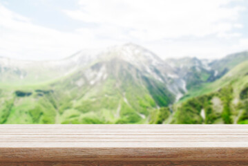 Wood table top stand with blur mountain landscape view background in spring. Food product display...