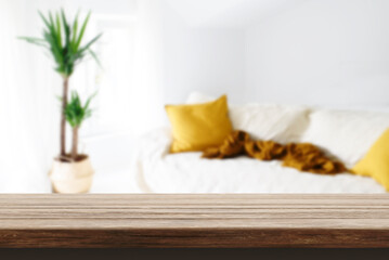 Wood table in cozy modern home interior. Blur living room background and tabletop desk backdrop...