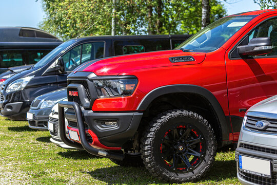Eging am See, bavaria, germany, 14. may 2022: A red dodge RAM 1500 rebel pick-up parking on a meadow between other cars