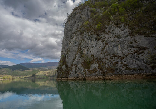 A series of cruises on the Drina River. Рeflections. A massive rock in the foreground.