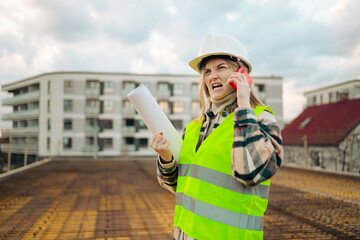 Angry and upset Caucasian 30s engineer woman wearing uniform and safety helmet under inspection and checking construction by phone. Industry concept