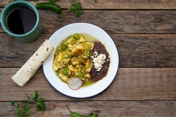 Egg with green sauce and refried beans. Mexican food