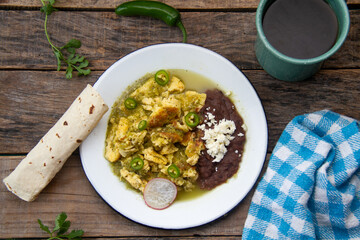 Egg with green sauce and refried beans. Mexican food