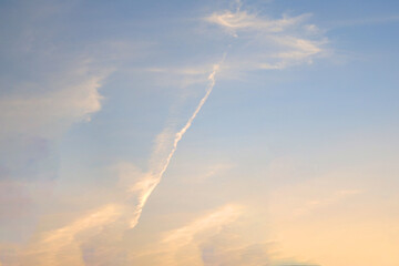 Fototapeta na wymiar ピンクの夕焼けと飛行機雲のような地震雲（東京都千代田区）
