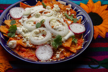 Red chilaquiles with cheese and sour cream. Mexican food