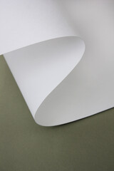 curved wavy white paper with green background