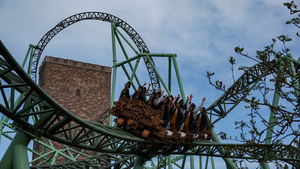 Sierksdorf, Germany - April.30.2022: Sierksdorf, Germany - April.30.2022: Young people have fun on the extreme steel rollercoaster "Der Schwur des Kärnan" in the theme park "Hansa-Park"  © D. Pfleiderer