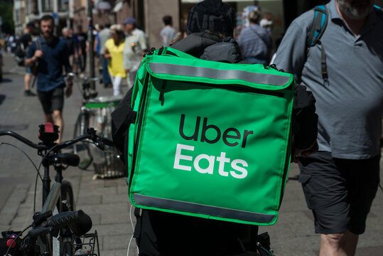 Strasbourg - France - 14 May 2022 - Portrait of uber eats delivery man in bicycle waiting in the street