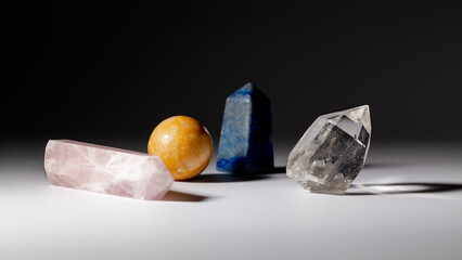 Various healing stone crystals for meditation or spiritual practices on gray background. Horizontal orientation
