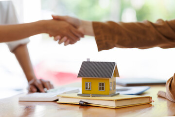 Signing contract agreement after the meeting to state organizations, Business meetings of real estate brokers and company presidents select a home model Construction concept.