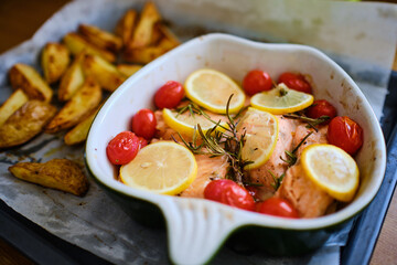 Salmon fish portions with cherry tomatoes and lemon