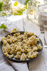 Acacia fried flowers on plate with napkin, forks, oil and sugar powder
