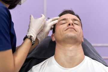 Relaxed patient getting a botox injection for facial rejuvenation treatment