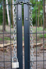 gate locked with a padlock - obrazy, fototapety, plakaty