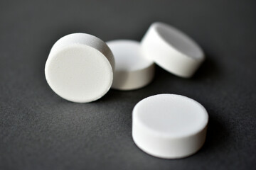 Fototapeta na wymiar White large round tablets on a gray background. Medicines.