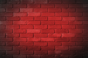 Ceglany mur pomalowany na czerwono.
