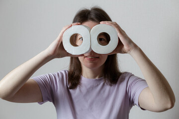 toilet paper concept. beautiful girl in a good mood, smiling, pretending to have toilet paper...