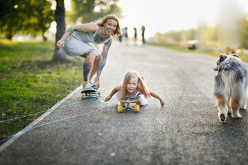 Young european mother and daughter skateboarding on the road