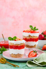 Crispy creamy strawberry trifle. Delicious summer layer dessert of shortbread crumbs, yogurt quark cream and strawberries. Selective focus