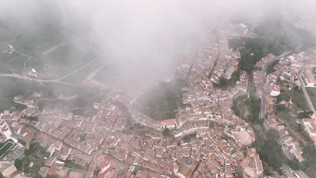 A mesmerizing flight over the city. Foggy atmosphere. City panorama opens up when flying high above the earth. 