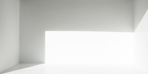 Light and shadow inside the empty white space room.