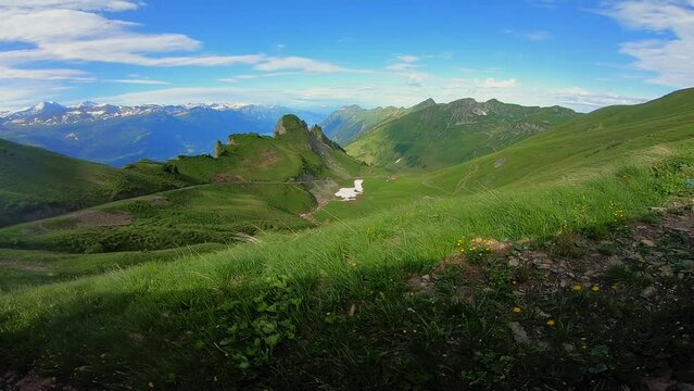Panning view of the valley in the swiss alps in Switzerland from the Brienzer Rothorn near Brienz with a clear blue sky and Faulhorn in sight