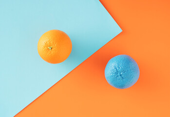 Creative arrangement made of orange on blue and orange backgrounds. Minimal fruit concept. Summer inspiration.