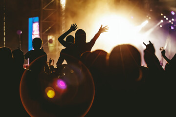 People dancing and having fun at summer festival party outdoor - Crowd with hands up celebrating...