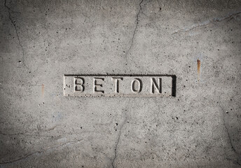 Grey textured concrete wall labeled Baton